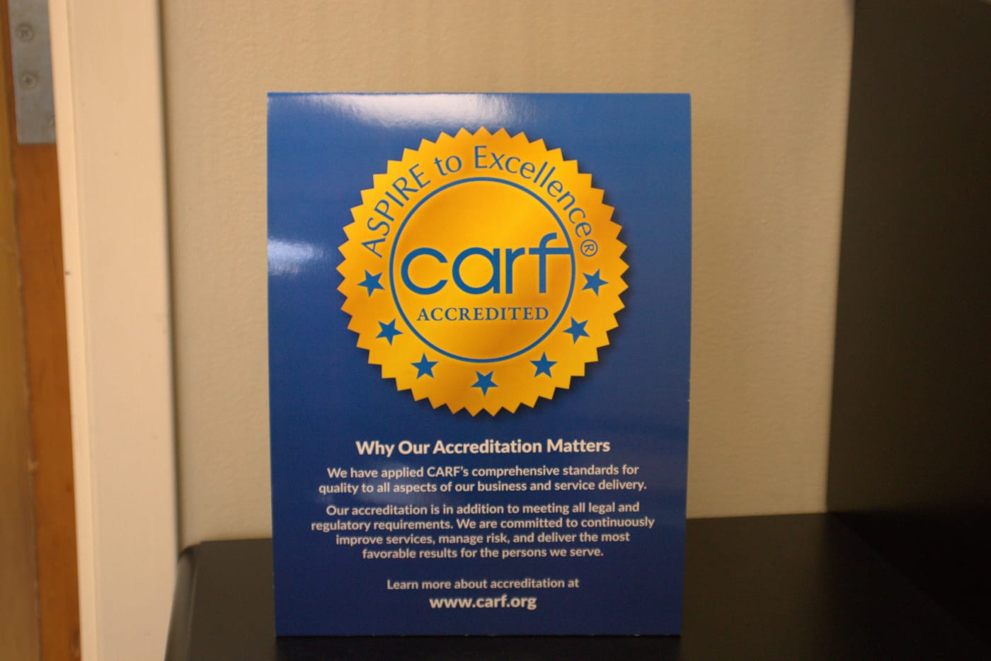 CARF 'Aspire to Excellence' accreditation sign displayed in the Southeastern Services Whiteville office